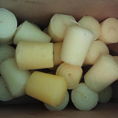 Assorted candles and holders including vintage wooden spool