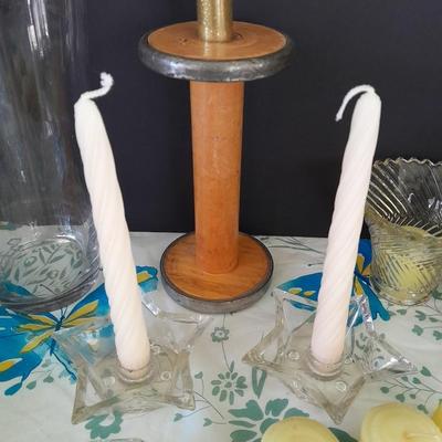 Assorted candles and holders including vintage wooden spool