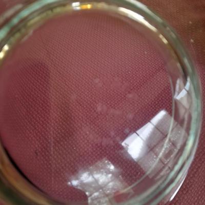 Assorted candles and holders including vintage wooden spool