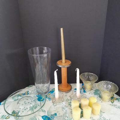 Assorted candles and holders including vintage wooden spool