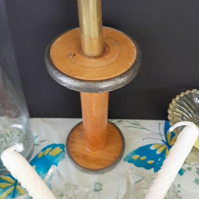 Assorted candles and holders including vintage wooden spool