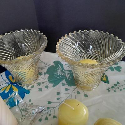 Assorted candles and holders including vintage wooden spool