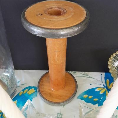 Assorted candles and holders including vintage wooden spool