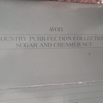 New in the box Avon Collectables, fish wind chime, Cat themed serving pieces, plate, and Wax candle maker