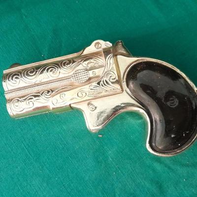 Two collectable Pistol Cologne bottles and a VHS on pistols