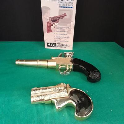 Two collectable Pistol Cologne bottles and a VHS on pistols