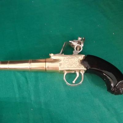 Two collectable Pistol Cologne bottles and a VHS on pistols