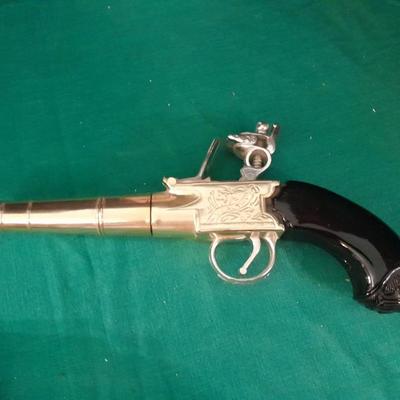 Two collectable Pistol Cologne bottles and a VHS on pistols