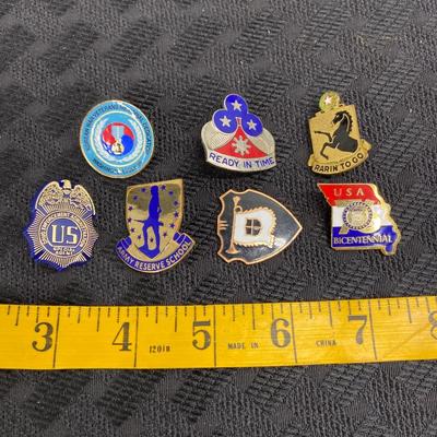A lot of seven various military pins