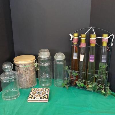 Glass lidded canisters and an oil / vinegar canister set with metal hanging rack