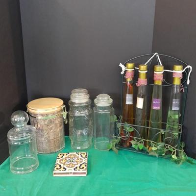 Glass lidded canisters and an oil / vinegar canister set with metal hanging rack