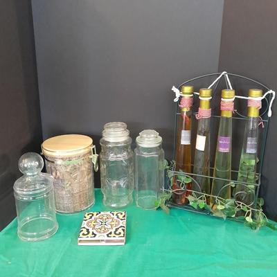 Glass lidded canisters and an oil / vinegar canister set with metal hanging rack
