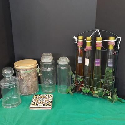 Glass lidded canisters and an oil / vinegar canister set with metal hanging rack