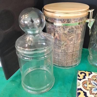 Glass lidded canisters and an oil / vinegar canister set with metal hanging rack