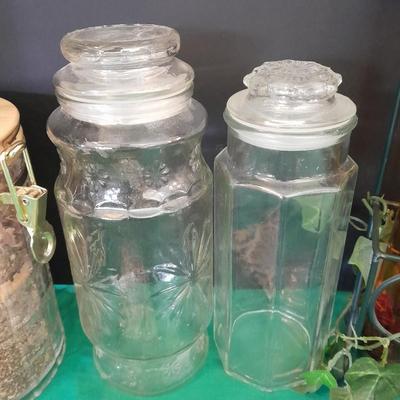 Glass lidded canisters and an oil / vinegar canister set with metal hanging rack