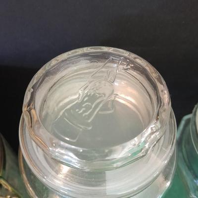 Glass lidded canisters and an oil / vinegar canister set with metal hanging rack