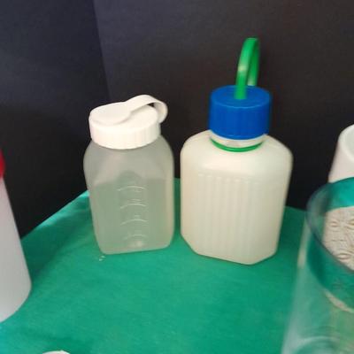 Assortment of plastic kitchen cups, and beverage coozie's