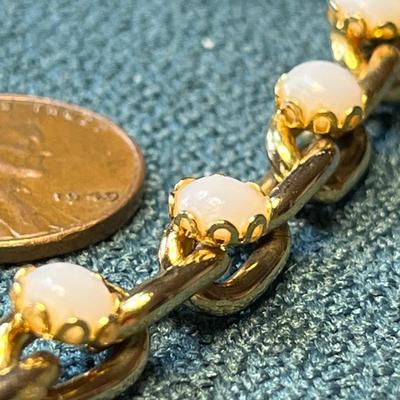SATINY WHITE STONES IN GOLD TONE CHARM STYLE BRACELET