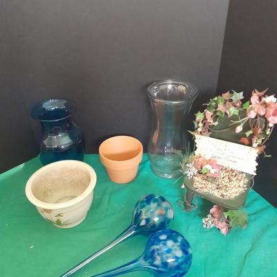 Gardening pots, glass bulb waterers, vase and a springtime chair decoration