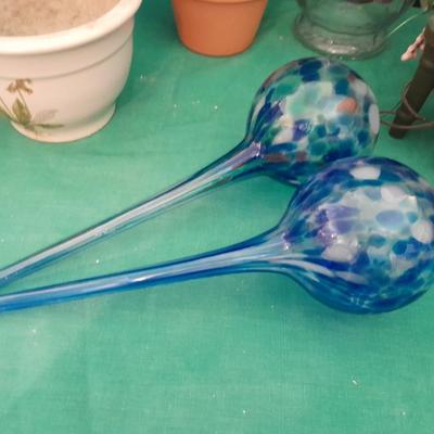 Gardening pots, glass bulb waterers, vase and a springtime chair decoration