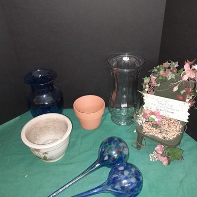 Gardening pots, glass bulb waterers, vase and a springtime chair decoration