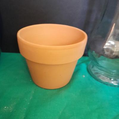 Gardening pots, glass bulb waterers, vase and a springtime chair decoration