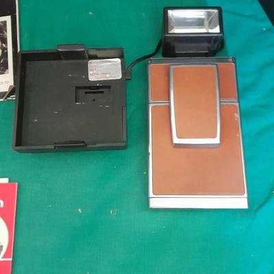 Vintage Polaroid sx-70 Land Camera with flash bulb and original instruction books