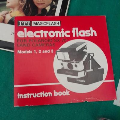 Vintage Polaroid sx-70 Land Camera with flash bulb and original instruction books