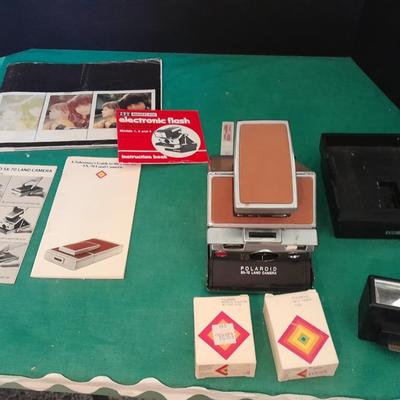 Vintage Polaroid sx-70 Land Camera with flash bulb and original instruction books