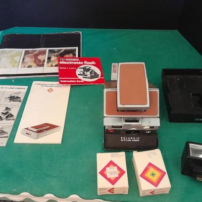 Vintage Polaroid sx-70 Land Camera with flash bulb and original instruction books