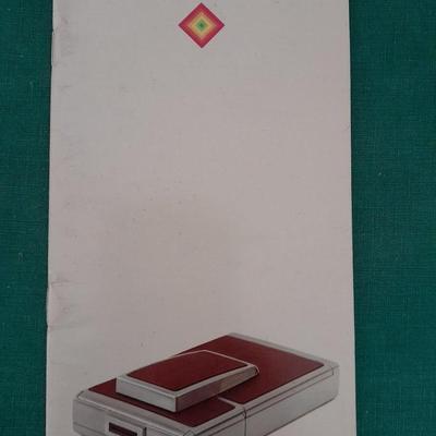 Vintage Polaroid sx-70 Land Camera with flash bulb and original instruction books