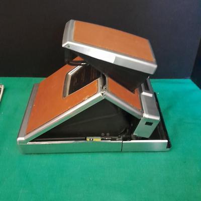 Vintage Polaroid sx-70 Land Camera with flash bulb and original instruction books