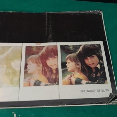 Vintage Polaroid sx-70 Land Camera with flash bulb and original instruction books