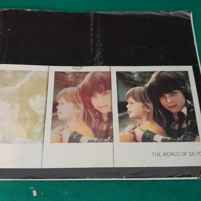 Vintage Polaroid sx-70 Land Camera with flash bulb and original instruction books