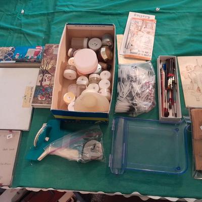 Artist Painting supplies including face painting brushes, Dymo label maker and lidded containers for beads and more