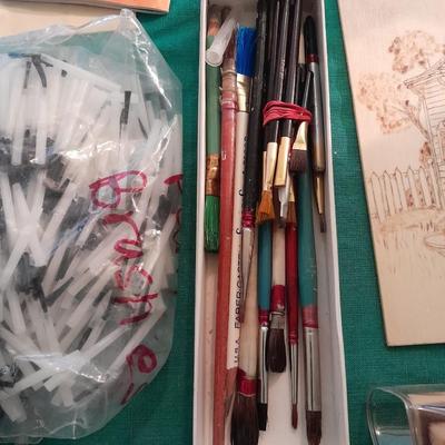 Artist Painting supplies including face painting brushes, Dymo label maker and lidded containers for beads and more