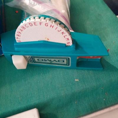 Artist Painting supplies including face painting brushes, Dymo label maker and lidded containers for beads and more