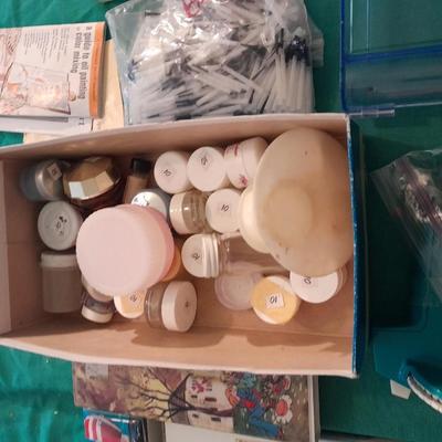Artist Painting supplies including face painting brushes, Dymo label maker and lidded containers for beads and more