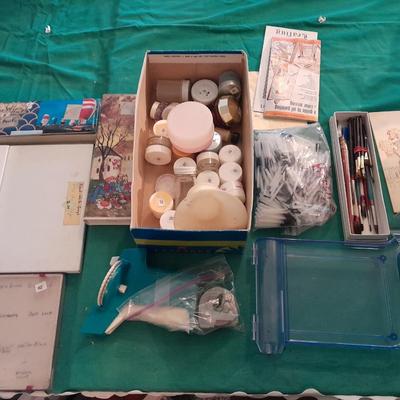 Artist Painting supplies including face painting brushes, Dymo label maker and lidded containers for beads and more