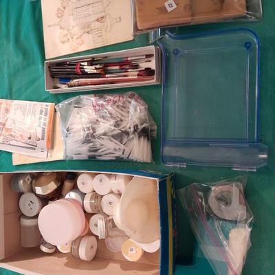 Artist Painting supplies including face painting brushes, Dymo label maker and lidded containers for beads and more