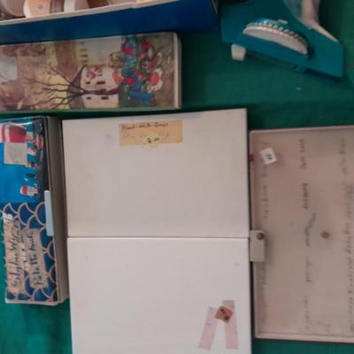 Artist Painting supplies including face painting brushes, Dymo label maker and lidded containers for beads and more