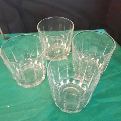 Set of 8 drinking glasses, a candle vase, and a treat dish