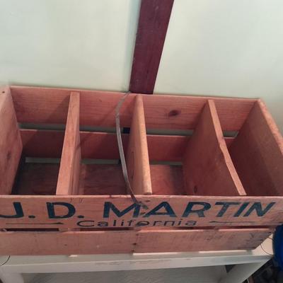 Divided wooden J.D. Martin California crate and tin vase with handle.