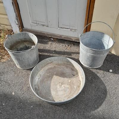 Two galvanized metal buckets and a shallow galvanized dish