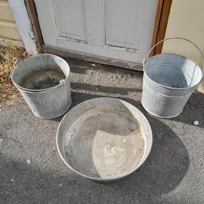 Two galvanized metal buckets and a shallow galvanized dish