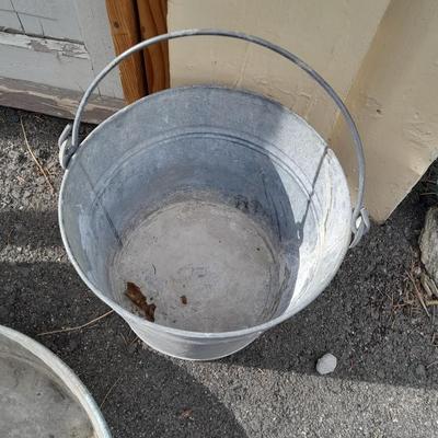 Two galvanized metal buckets and a shallow galvanized dish