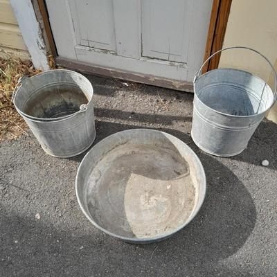 Two galvanized metal buckets and a shallow galvanized dish