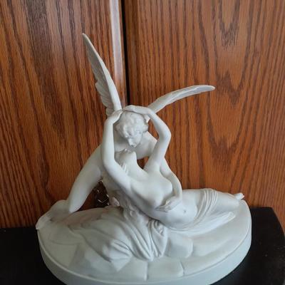 Black metal wall shelf with white Cupid and Psyche Statue