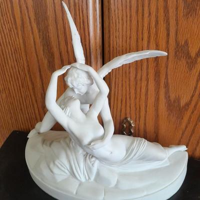 Black metal wall shelf with white Cupid and Psyche Statue