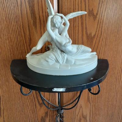 Black metal wall shelf with white Cupid and Psyche Statue